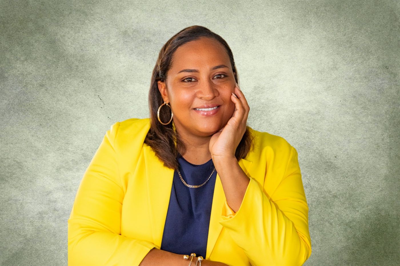 Tiffany Swift of Tierra Belize, smiling in a yellow blazer
